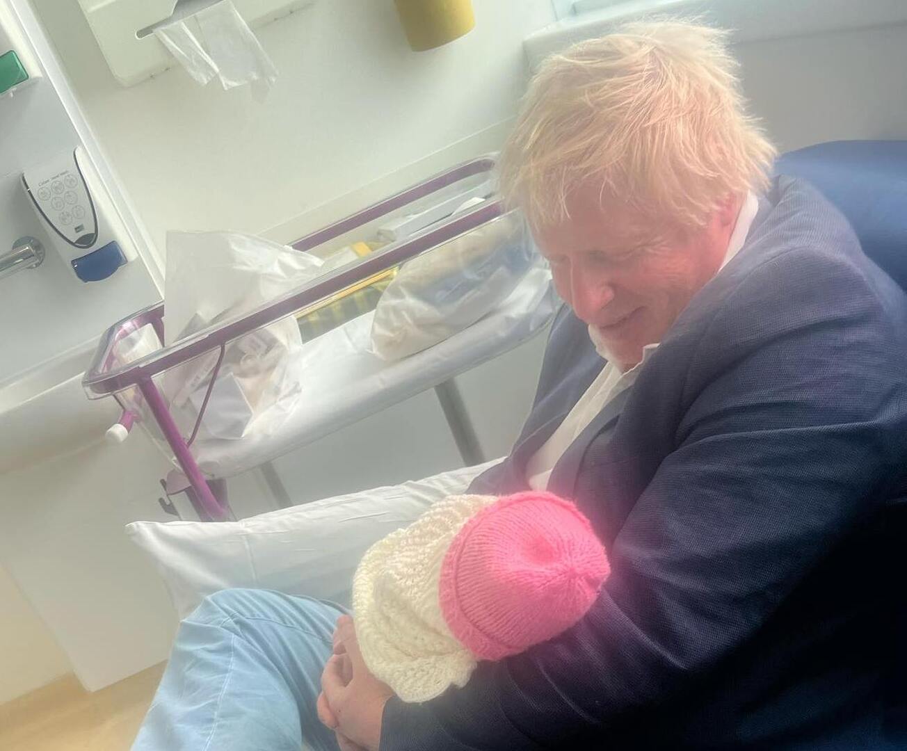 Boris Johnson holding his newborn baby daughter.